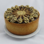 This chocolate cheesecake is the same as the fruit cheesecake in this gallery, but topped with a chocolate fudge frosting and chocolate-walnut  dipped rolled cookies. 